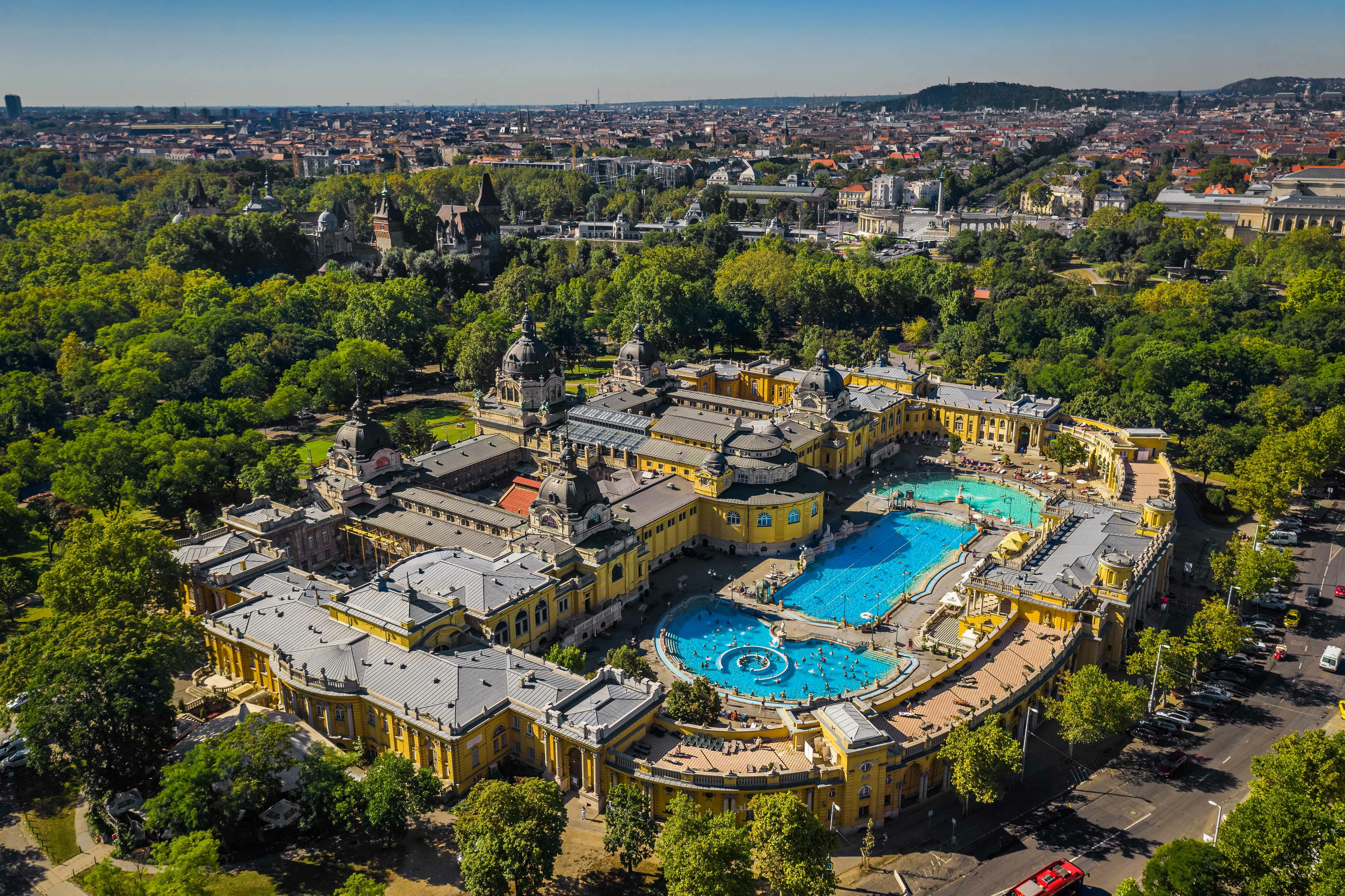 Széchenyi Baths outdoor thermal pools in Budapest, Hungary, with people enjoying the warm water.