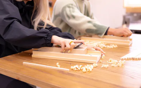 Participants crafting chopsticks at a workshop near Sensoji Temple, Asakusa, Tokyo.