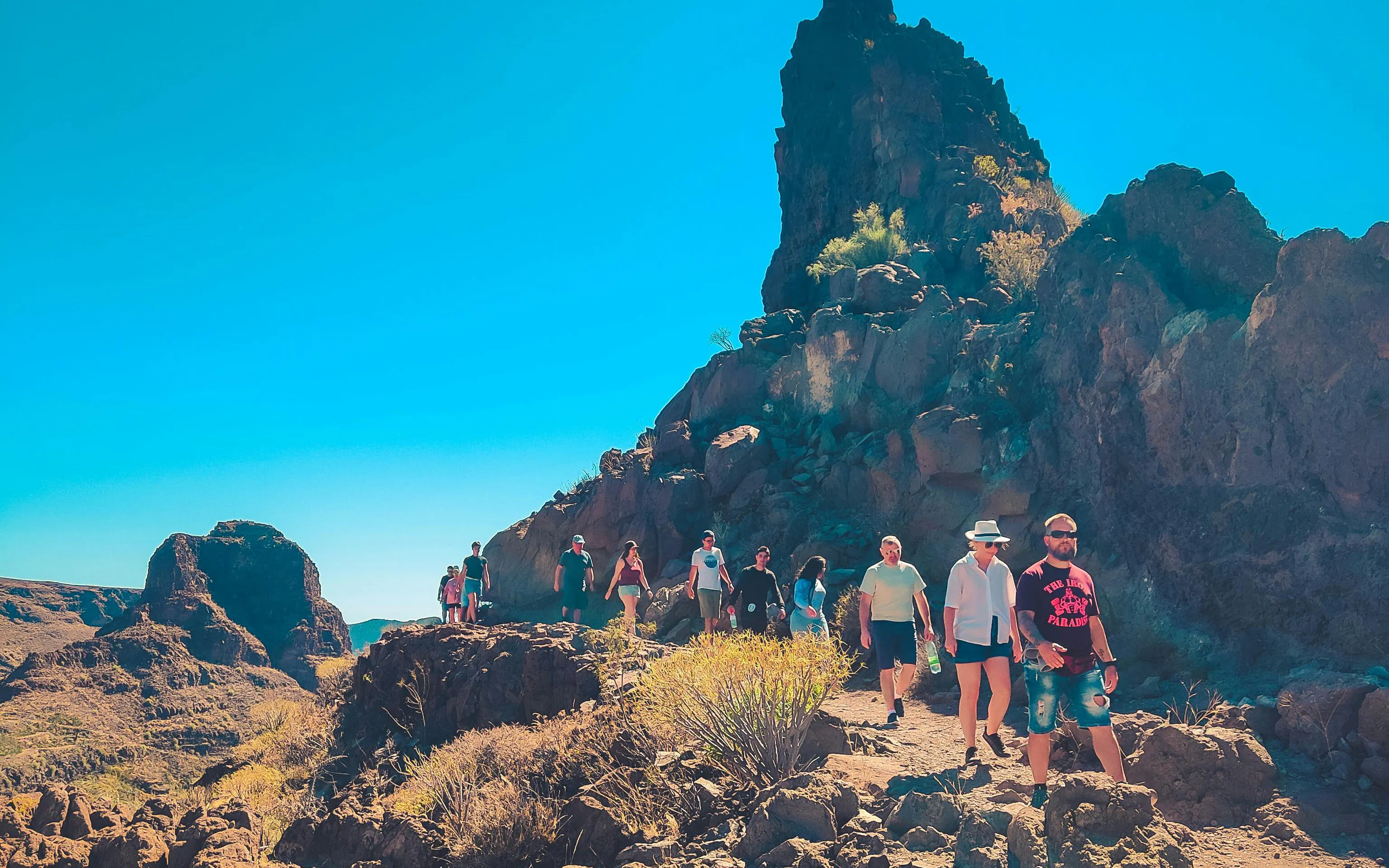 Hikers exploring rocky terrain on the Red Canyon Tour in Gran Canaria.