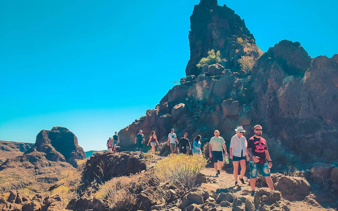Hikers exploring rocky terrain on the Red Canyon Tour in Gran Canaria.