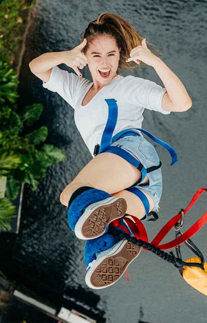 Person bungee jumping at Skypark Cairns over water.