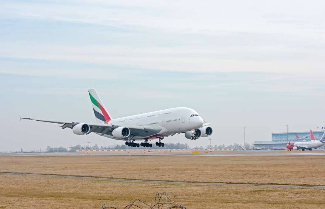 Emirates A380 landing at Dubai airport runway.