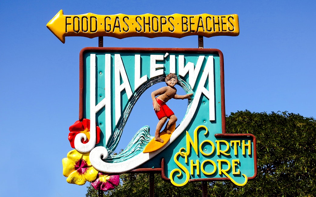 Haleiwa North Shore sign with surfer and flowers, Surfing Town of Haleiwa.
