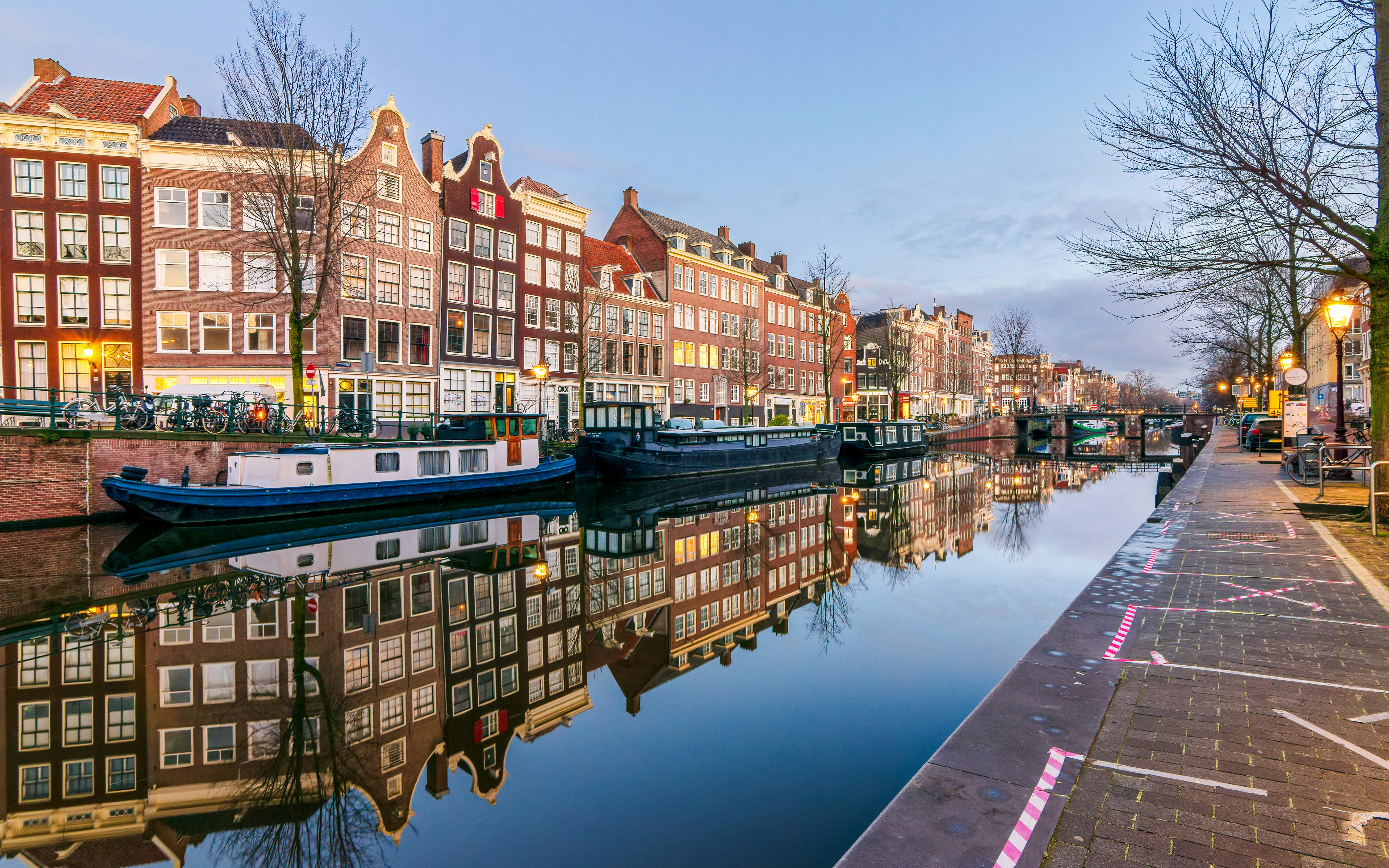 Canal houses and boats along a canal on Harbour Street, Amsterdam.