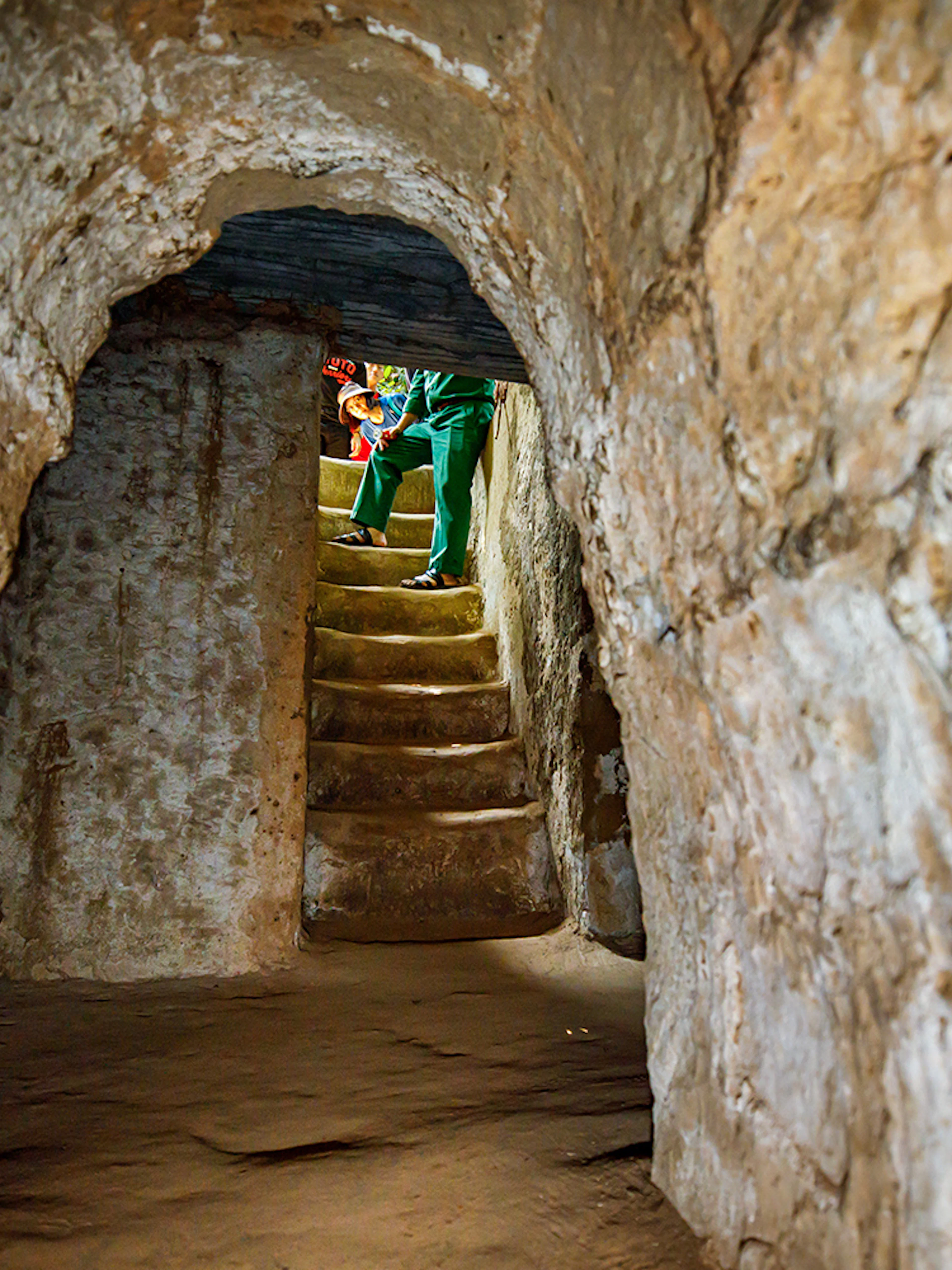 Stairs inside Cu Chi Tunnels with a guide leading a private tour.