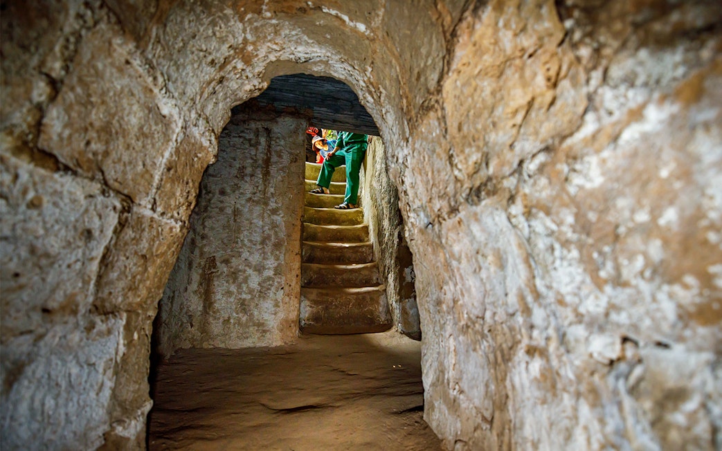 Stairs inside Cu Chi Tunnels with a guide leading a private tour.