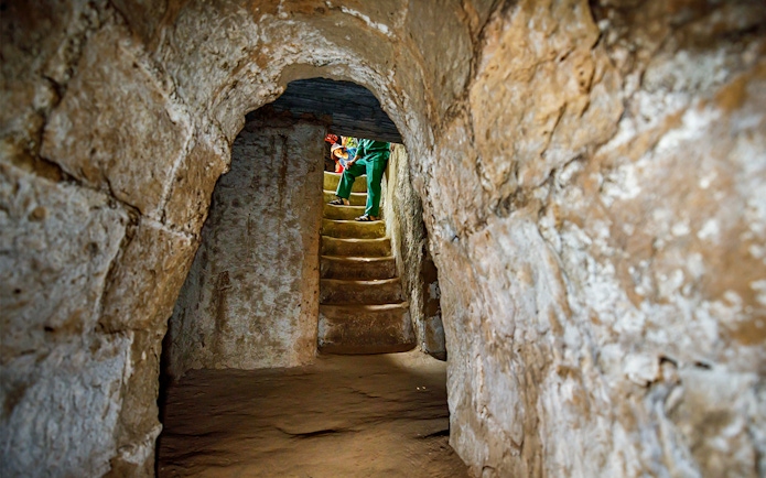 Stairs inside Cu Chi Tunnels with a guide leading a private tour.