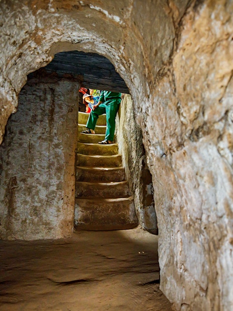 Stairs inside Cu Chi Tunnels with a guide leading a private tour.