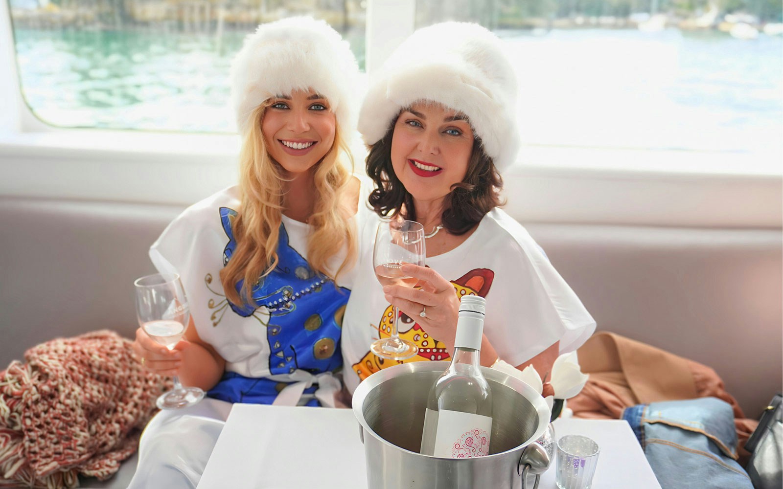 Women enjoying drinks on Abba Tribute Show Cruise, Sydney.