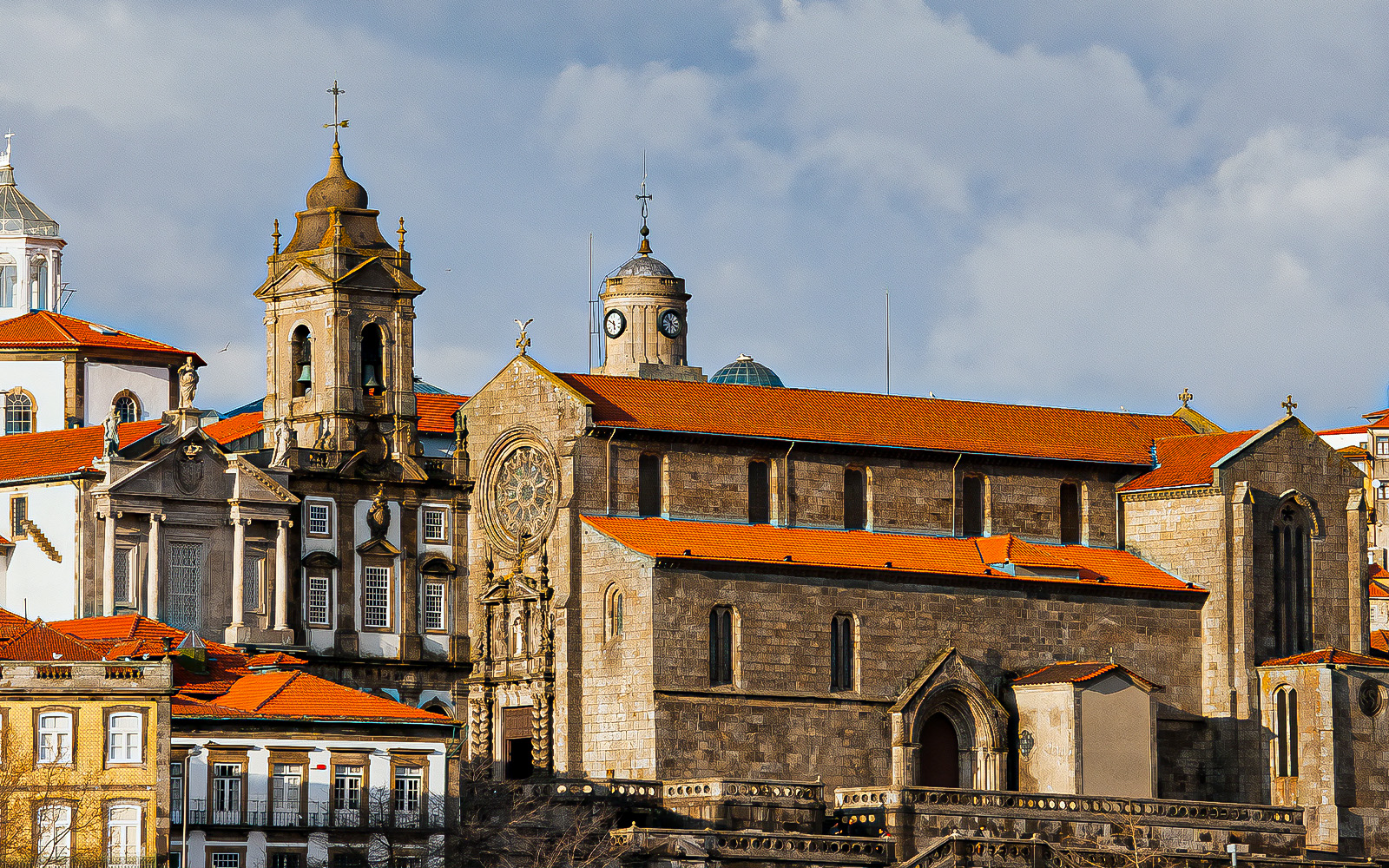 Monument Church of St. Francis in Porto with ornate facade and red-tiled roof.