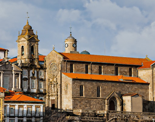 Monument Church of St. Francis in Porto with ornate facade and red-tiled roof.