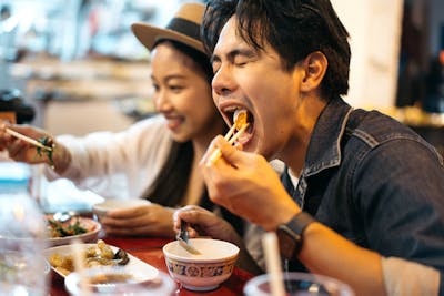 Tourists eating Thai food