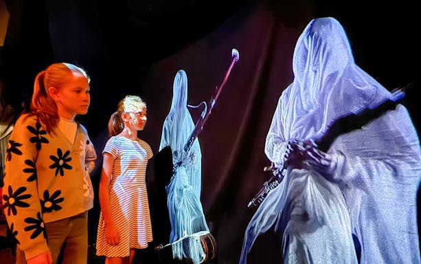 Guests interacting with holographic musicians at Mozart Interactive Museum, Prague.