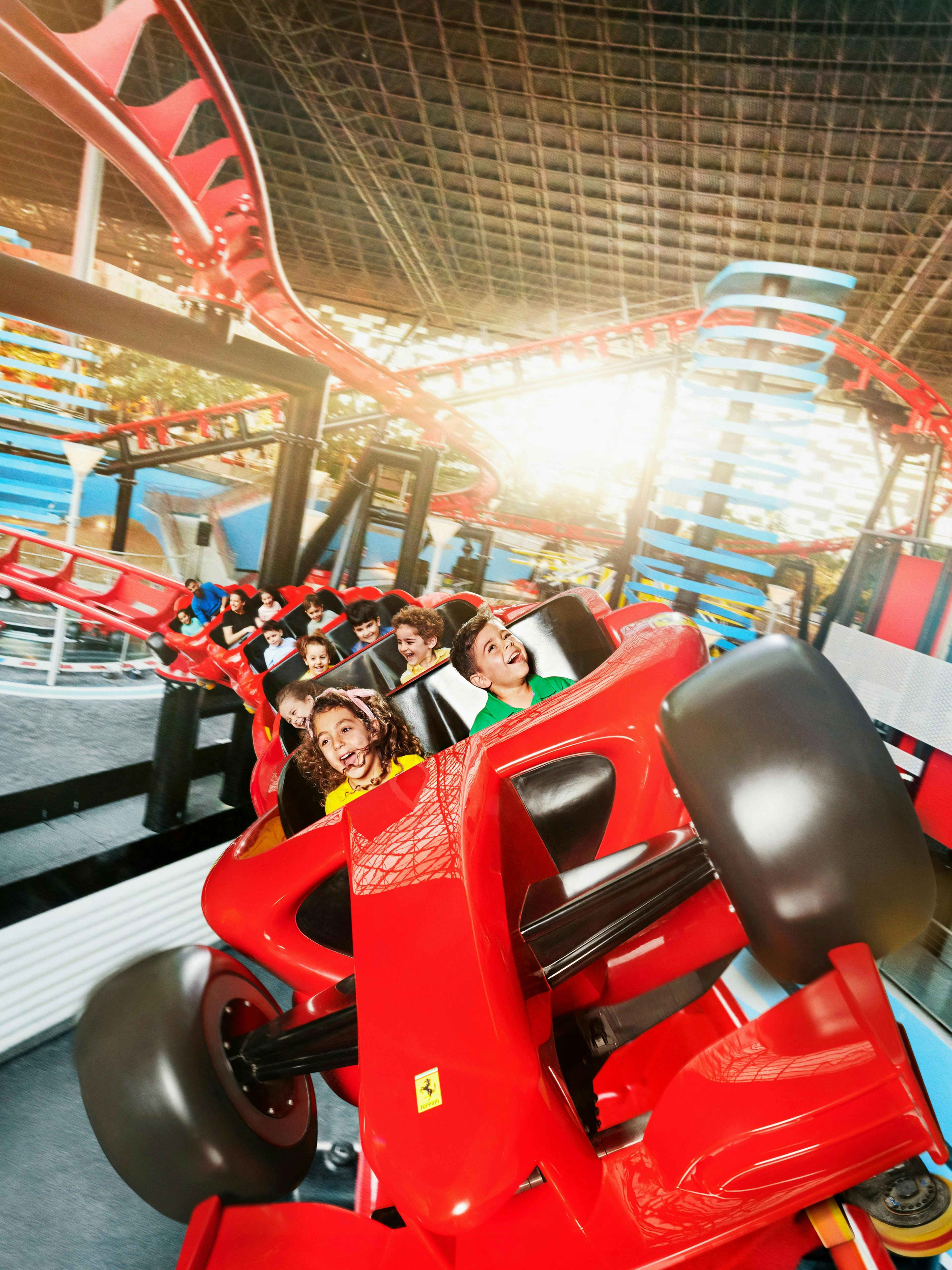 Roller coaster ride at Ferrari World Abu Dhabi with excited passengers.