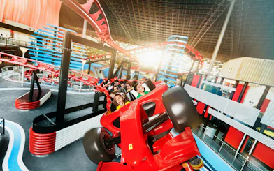 Roller coaster ride at Ferrari World Abu Dhabi with excited passengers.
