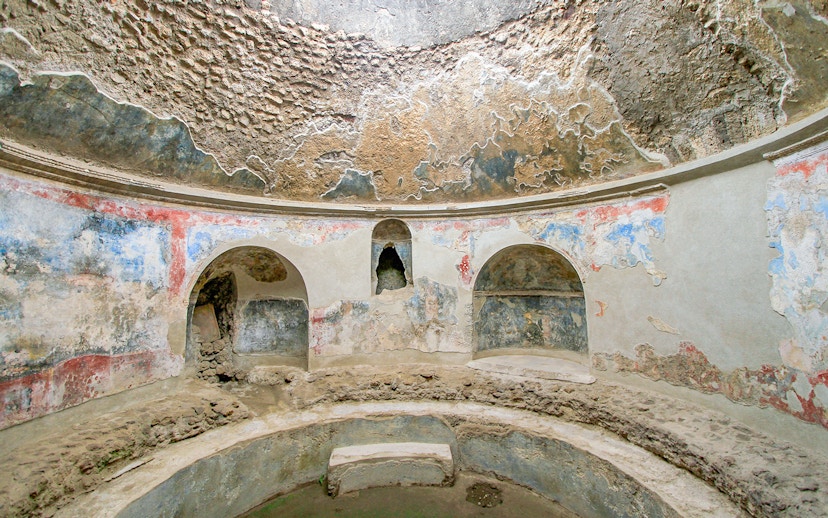 Stabian Baths in Pompeii with ancient frescoes and stone seating.