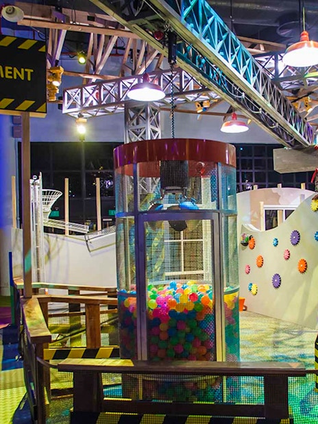Interactive exhibit at Science Centre Singapore featuring colorful gears and play area.