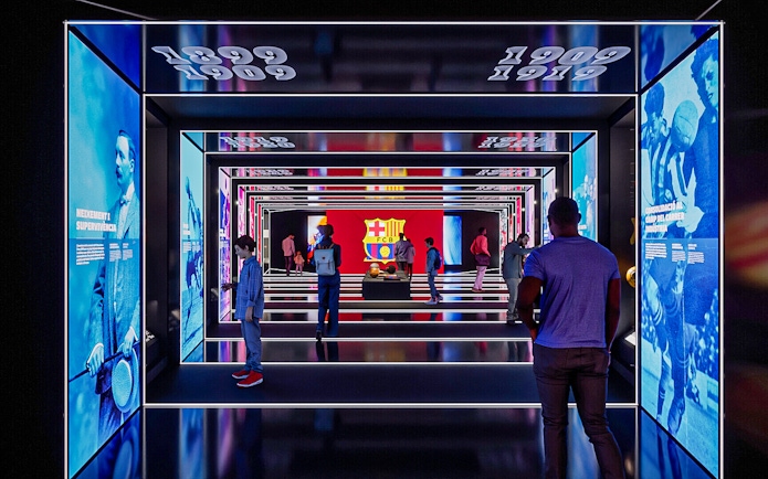 FC Barcelona museum exhibit with historical displays and visitors exploring.
