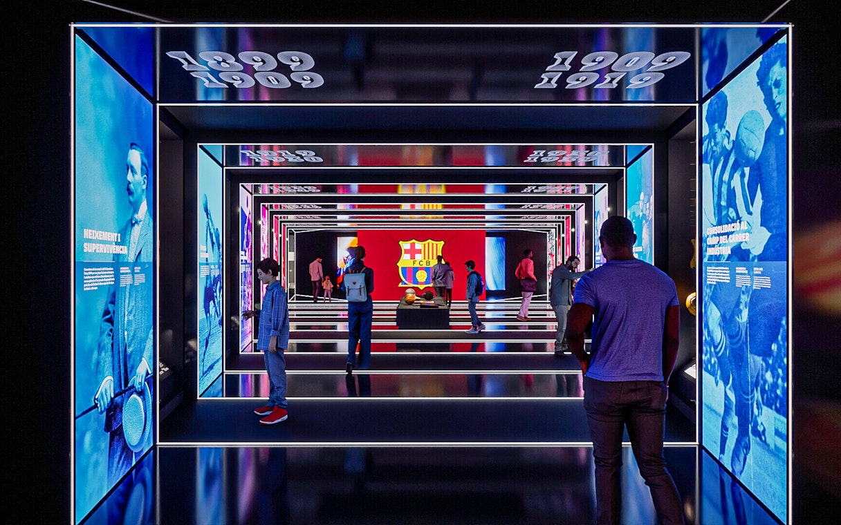 FC Barcelona museum exhibit with historical displays and visitors exploring.