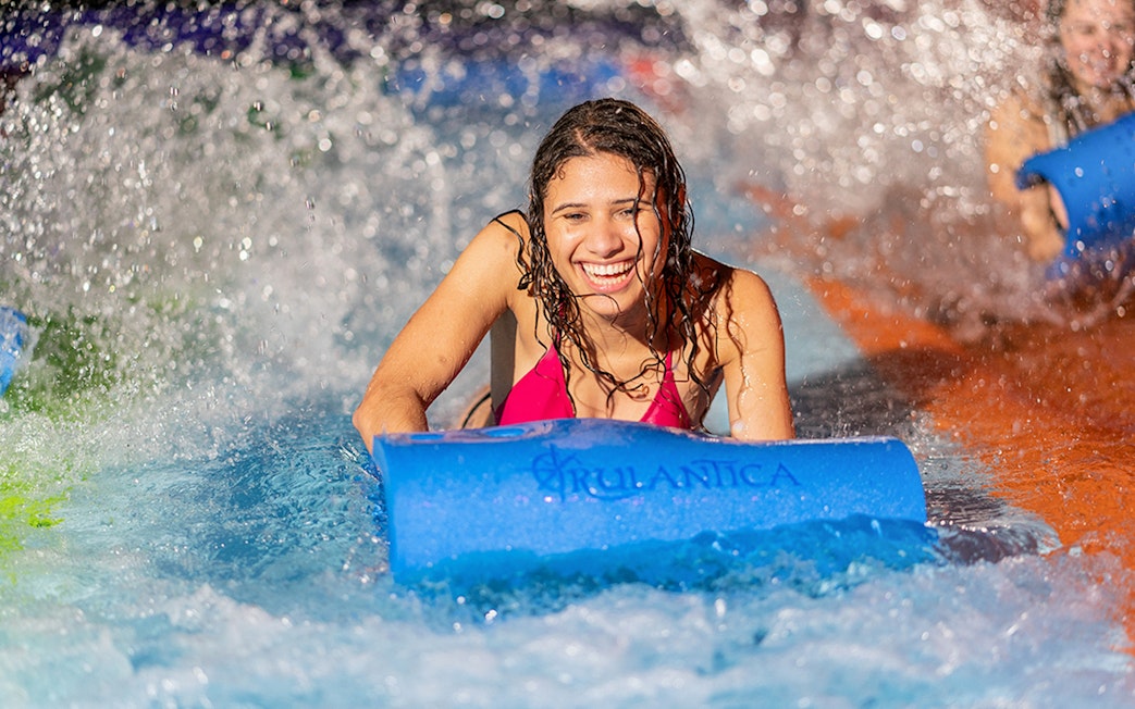 Person enjoying water slide at Rulantica water park.