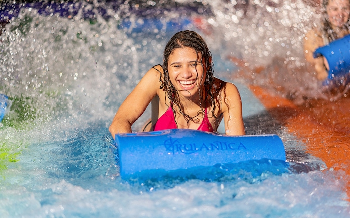 Person enjoying water slide at Rulantica water park.