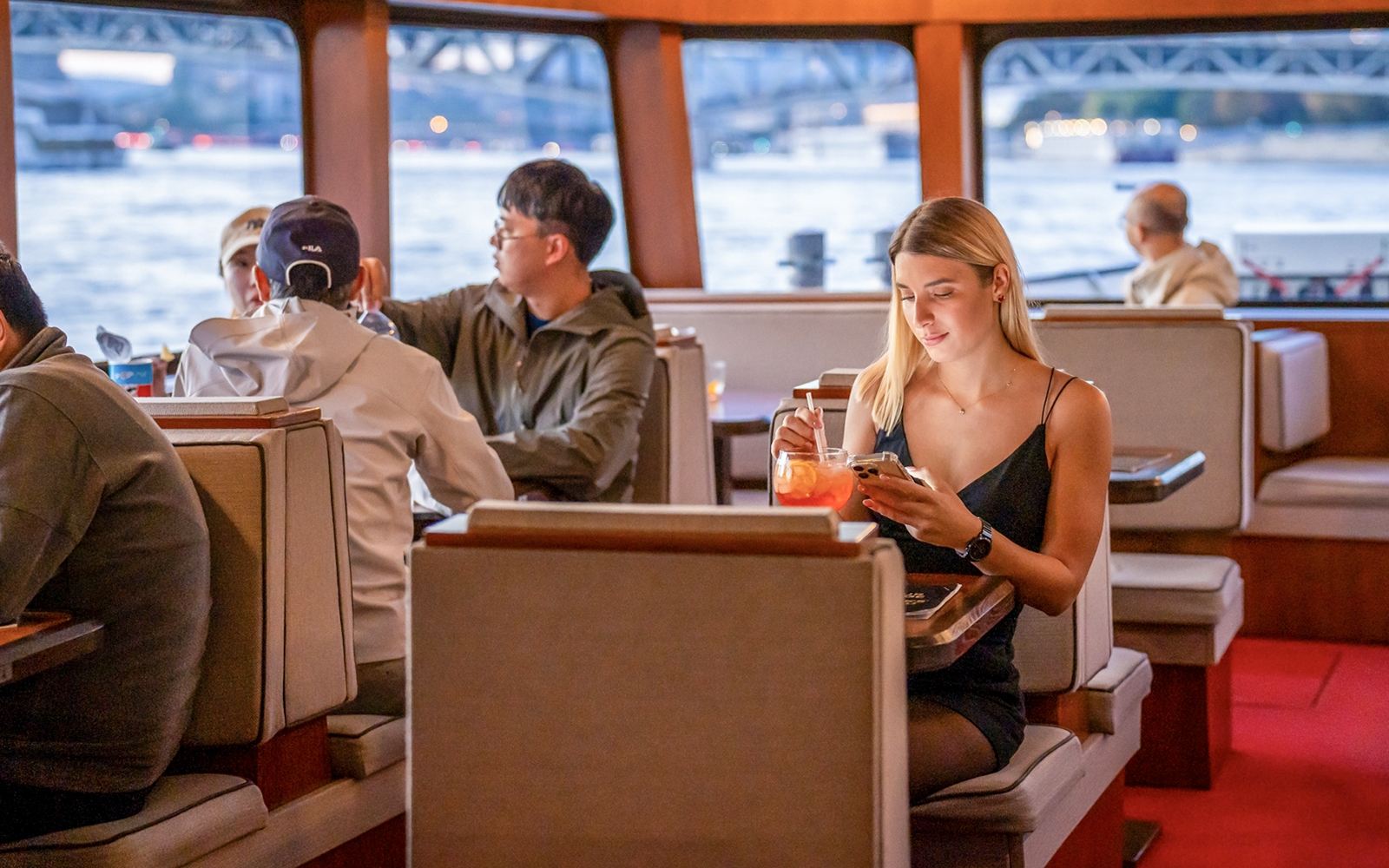 Guests enjoying river views on Elegant Premium Sightseeing Cruise.