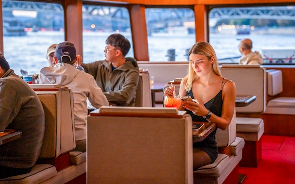 Guests enjoying river views on Elegant Premium Sightseeing Cruise.