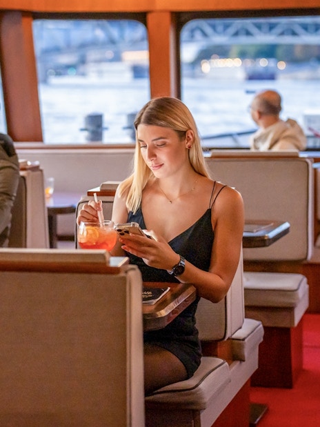 Guests enjoying river views on Elegant Premium Sightseeing Cruise.