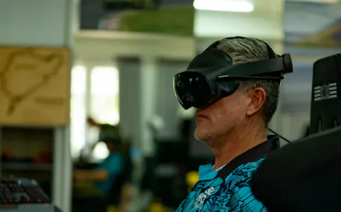 Man using VR headset for flight simulation at SIMPRO Academy, Phuket.