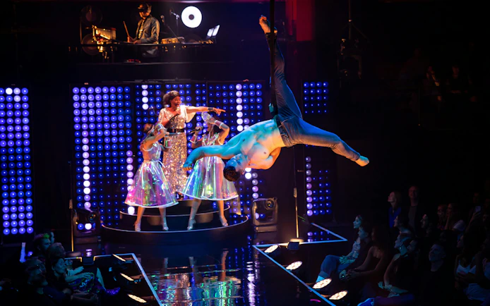 Aerial performer and singers on stage during Velvet Inferno show in Sydney.