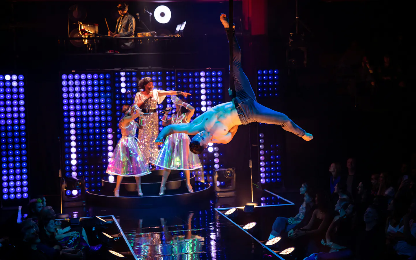 Aerial performer and singers on stage during Velvet Inferno show in Sydney.
