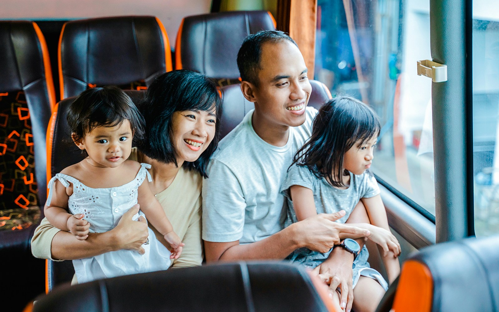 Family enjoying a coach transfer bus ride together.