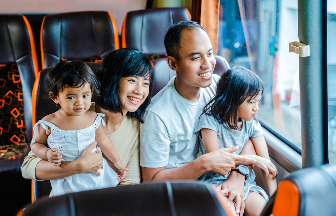 Family enjoying a coach transfer bus ride together.