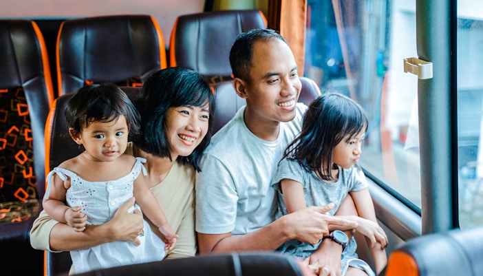 Family enjoying a coach transfer bus ride together.