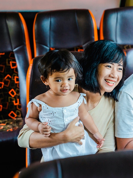 Family enjoying a coach transfer bus ride together.