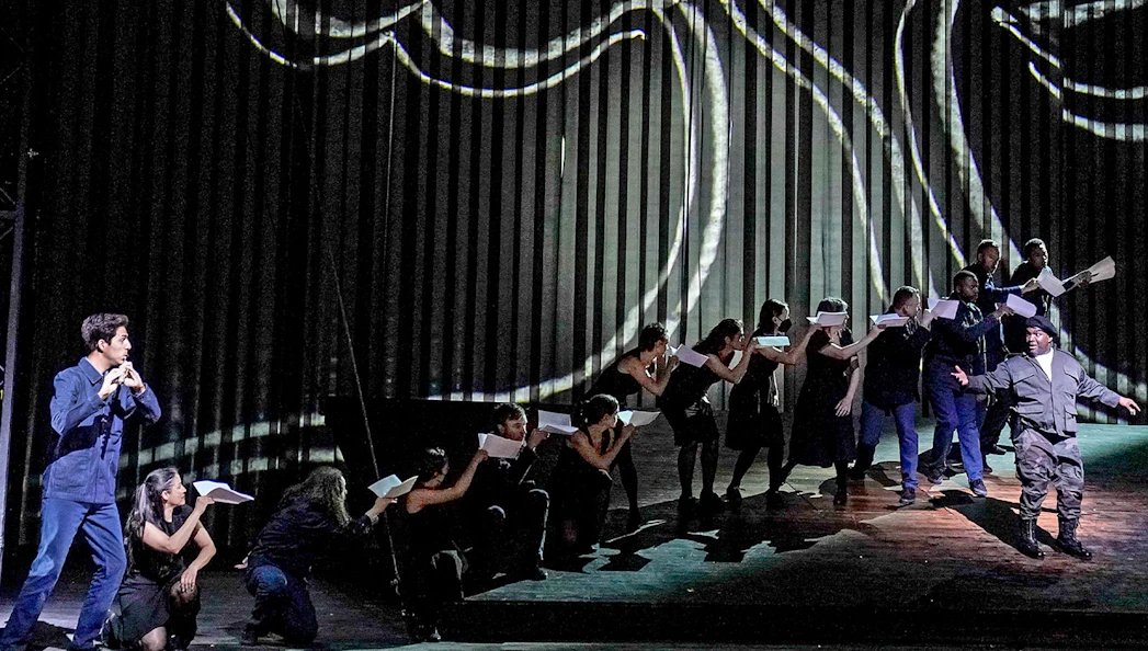 Performers on stage during a scene from Die Zauberflöte opera.