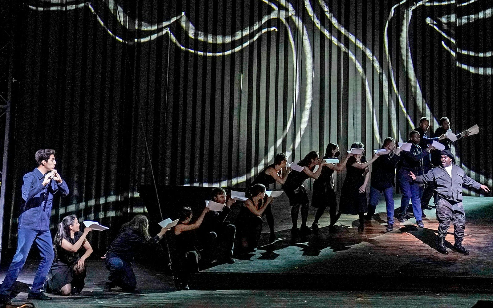 Performers on stage during a scene from Die Zauberflöte opera.