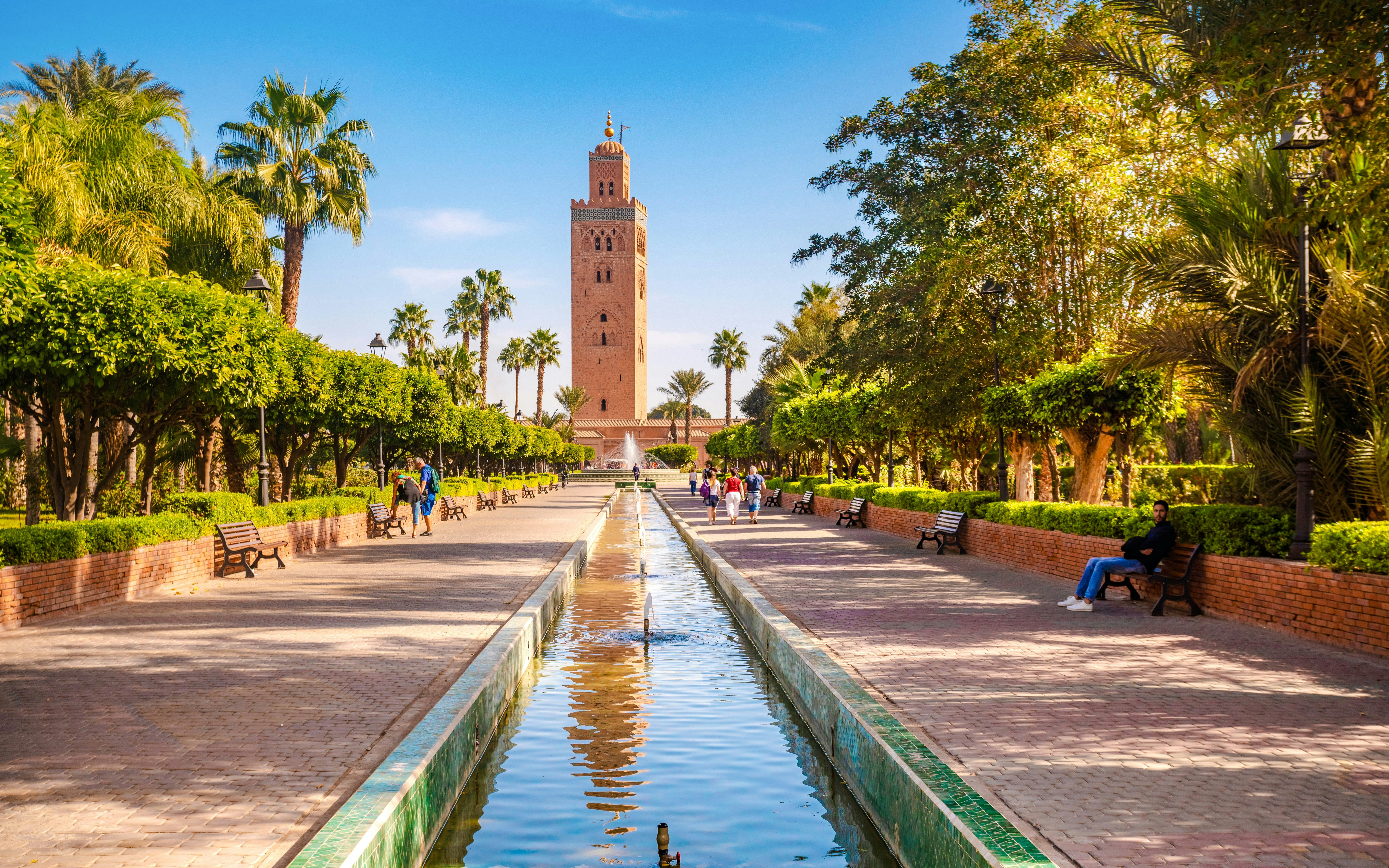 Koutoubia Mosque in Marrakech with gardens and fountain in foreground.