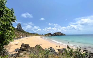 Beach view with rocky cliffs and ocean, Noronha Outrigger Canoe Experience, Sao Paulo.