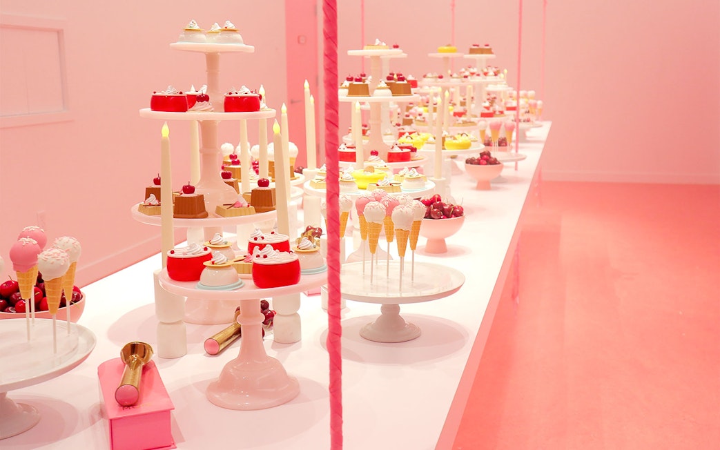 Five ice cream stations with diverse flavors in a vibrant pink market setting.