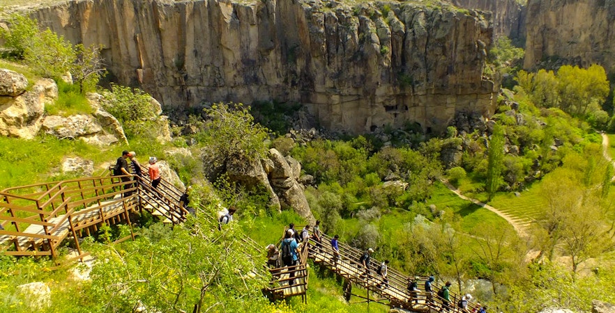 Visitors walking on a wooden path in Ihlara Valley, South Cappadocia.