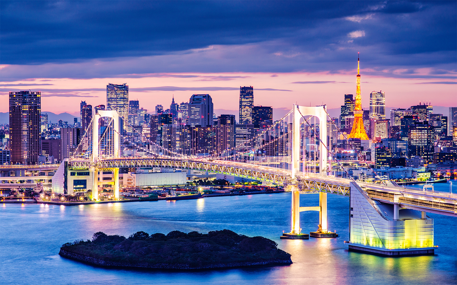 Odaiba also known as the Rainbow Bridge lit up during evening