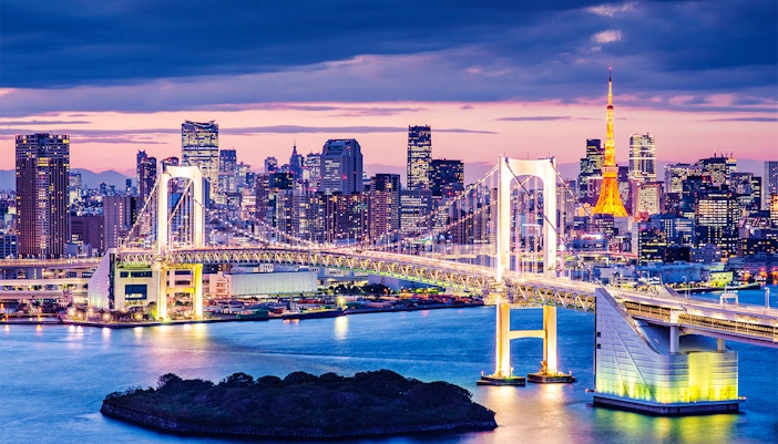 Odaiba also known as the Rainbow Bridge lit up during evening
