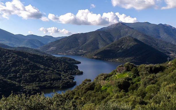 Mountainous landscape with a lake on the Guided Cogas History and Culture Day Trek.