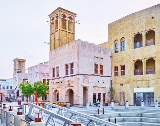 Traditional architecture in Souq Waqif, Doha, Qatar, featuring wind towers and historic buildings.