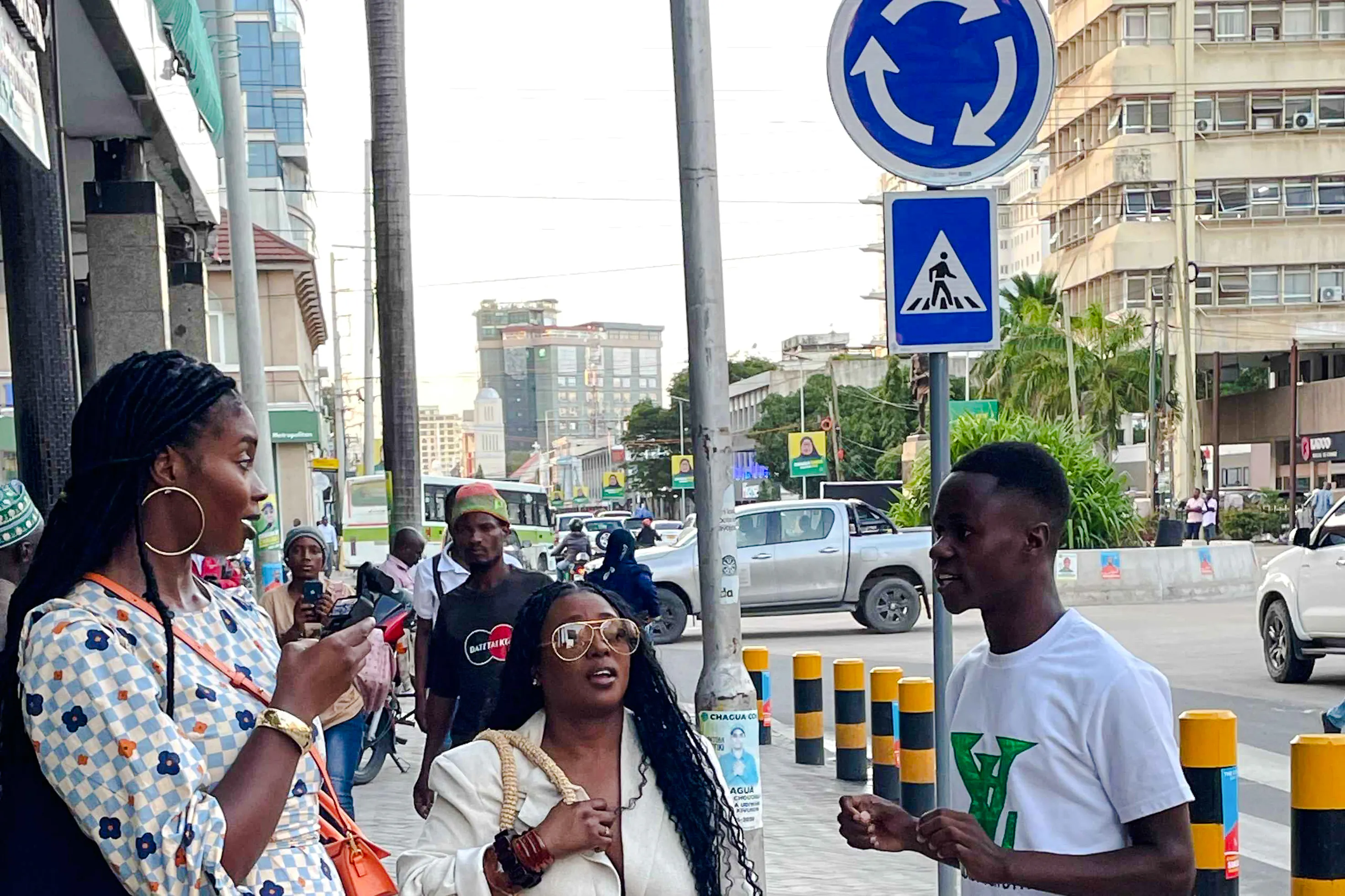 Tour guide leading a group through Dar es Salaam's bustling streets, highlighting local culture and history.