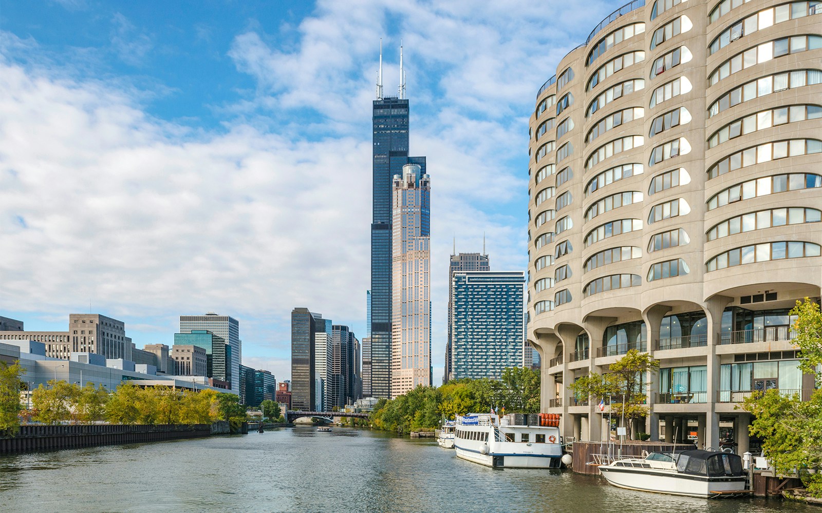 Chicago skyline with boats on the river during architecture cruise.