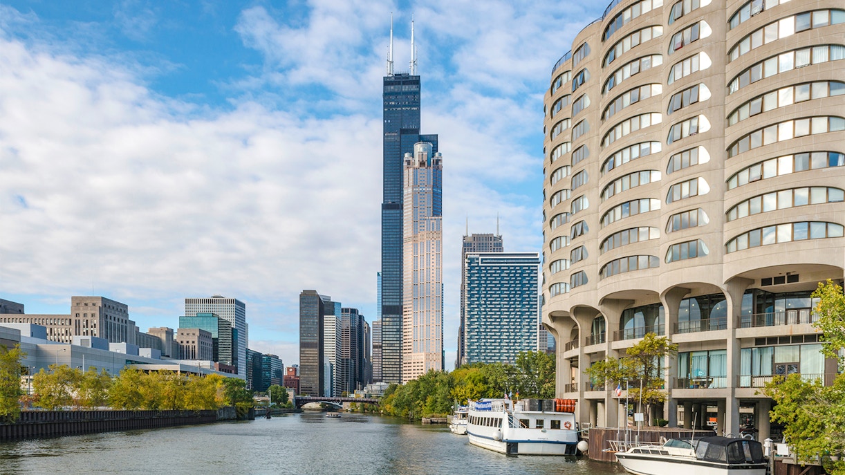 Chicago skyline with boats on the river during architecture cruise.
