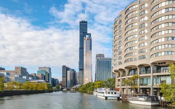 Chicago skyline with boats on the river during architecture cruise.