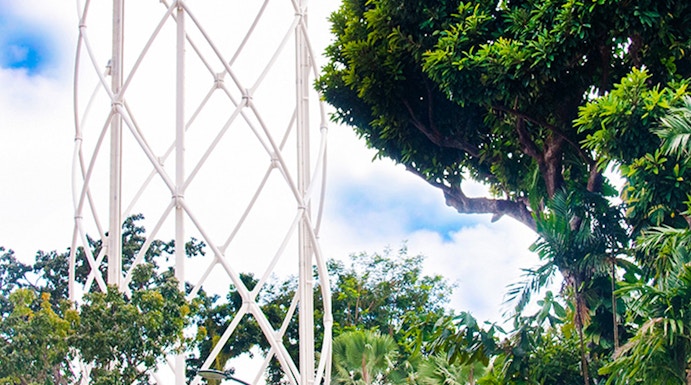 SkyHelix Sentosa ride at Imbiah Lookout, surrounded by lush greenery.